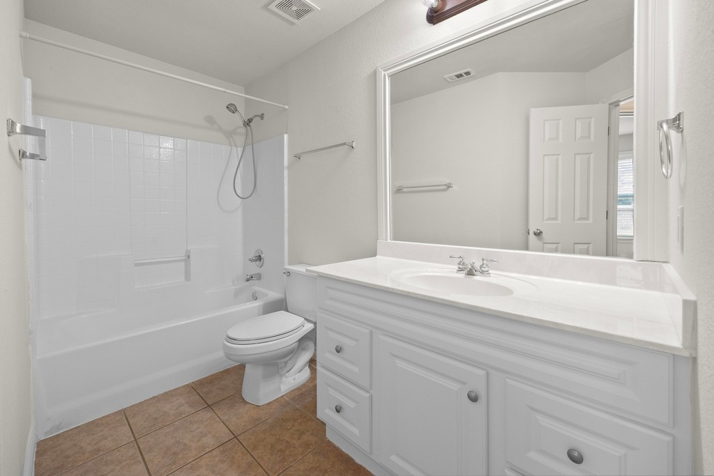 2832 Mission Tejas Drive Pflugerville, TX 78660 - Photo 25 of 30 a bathroom with a double vanity sink toilet and shower