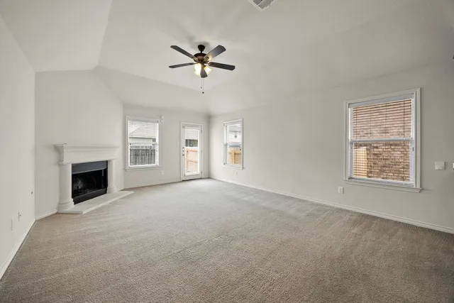 a view of empty room with a fireplace