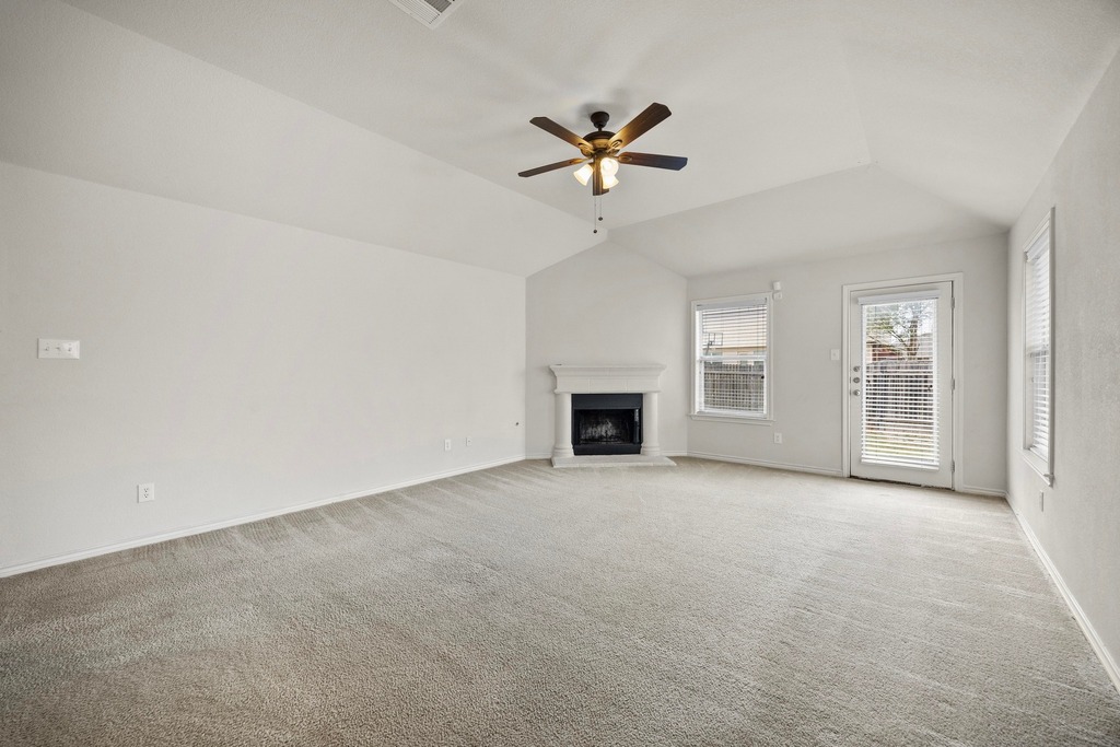 2832 Mission Tejas Drive Pflugerville, TX 78660 - Photo 7 of 30 an empty room with windows and fireplace