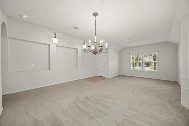 a view of a chandelier fan and a chandelier fan in a room