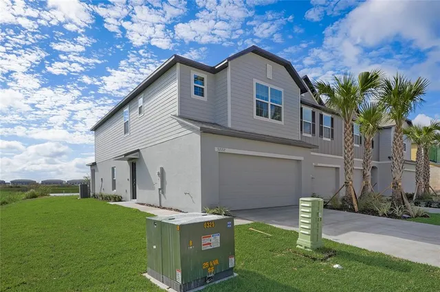 a front view of house with a garden