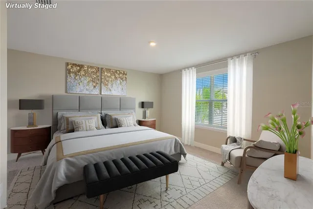 a bedroom with a large bed and a potted plant