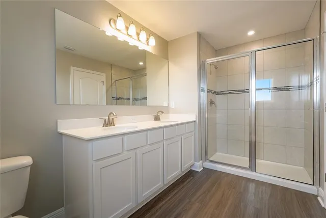a bathroom with a shower sink and mirror