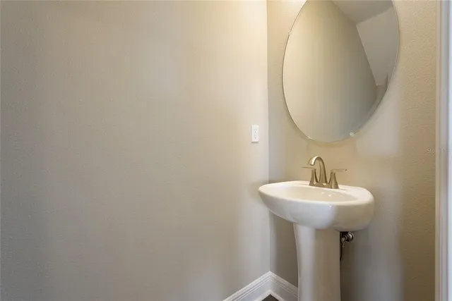 a bathroom with a sink a mirror and a toilet
