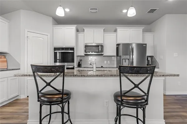 a kitchen with sink and cabinets