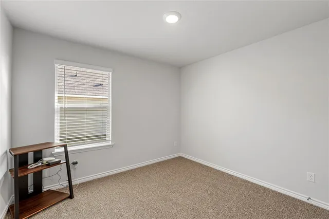 a kitchen with stainless steel appliances wooden cabinets and chairs