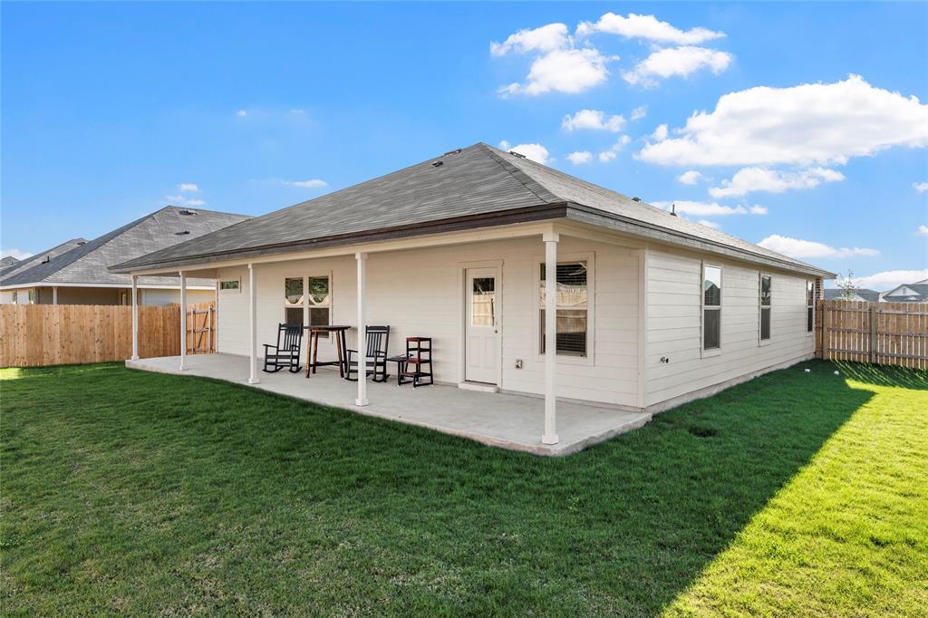 10761 Chesson Flts Drive Waco, TX 76708 - Photo 28 of 30 a front view of a house with a yard porch and outdoor seating