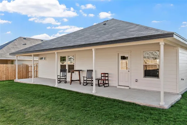 a front view of a house with a yard porch and outdoor seating