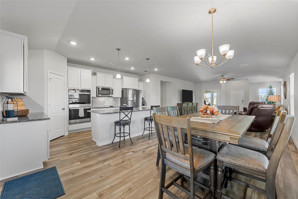 10761 Chesson Flts Drive Waco, TX 76708 - Photo 9 of 30 a view of a dining room and livingroom with furniture wooden floor a chandelier