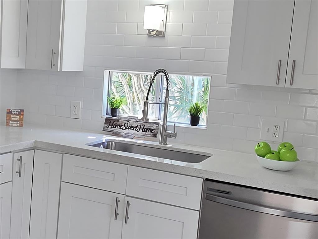 2050 Southwest 83rd Terrace Davie, FL 33324 - Photo 16 of 30 a kitchen with stainless steel appliances white cabinets and a window