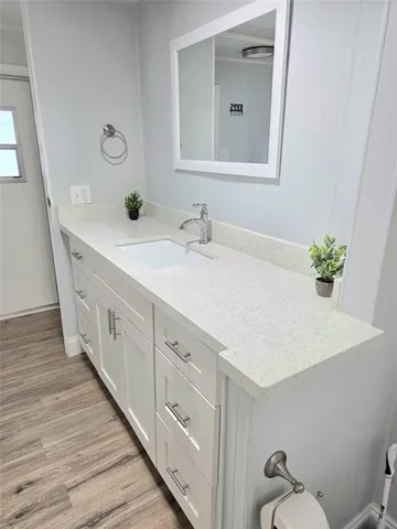 a spacious bathroom with a sink and a mirror