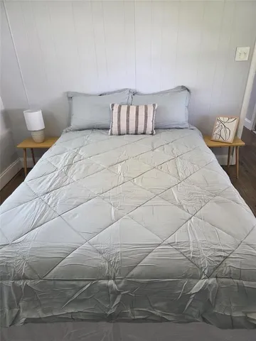 a bedroom with a bed and a night stand