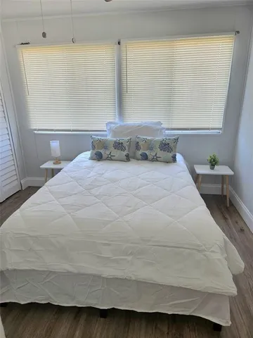 a large white bed in a small room