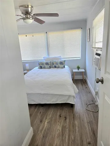 a living room with a bed furniture and a large window