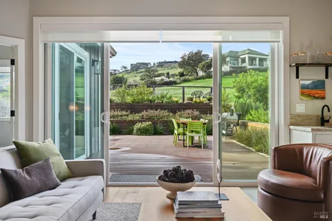 a living room with furniture and a floor to ceiling window