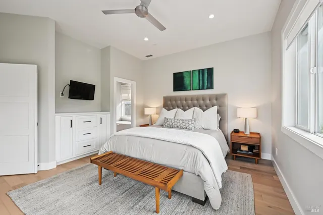 a bedroom with a bed and a flat screen tv