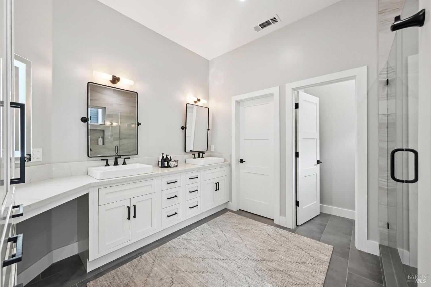 3761 Cross Creek Road Santa Rosa, CA 95403 - Photo 20 of 44 a spacious bathroom with a double vanity sink a mirror and shower