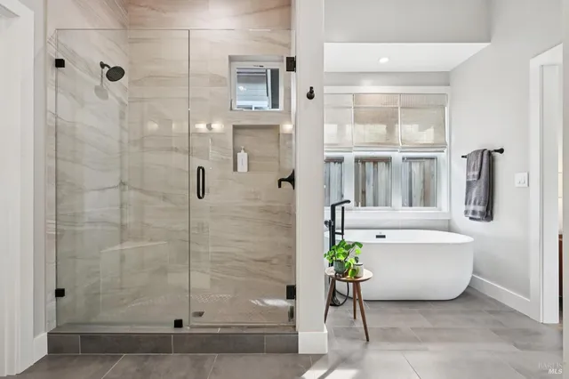 a bathroom with a bathtub and shower