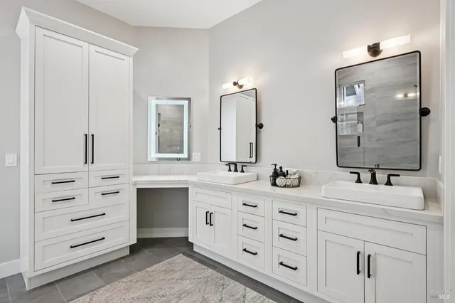 a bathroom with a double vanity sink mirror and