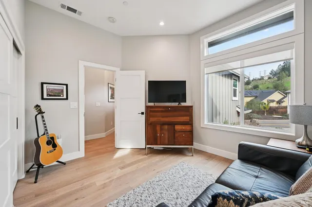 a view of a livingroom with furniture and a window