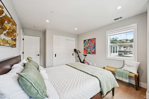 a bedroom with a large bed and a window