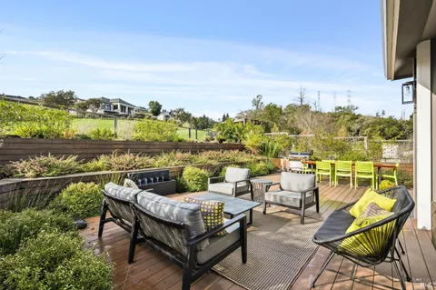 a terrace with outdoor seating and city view