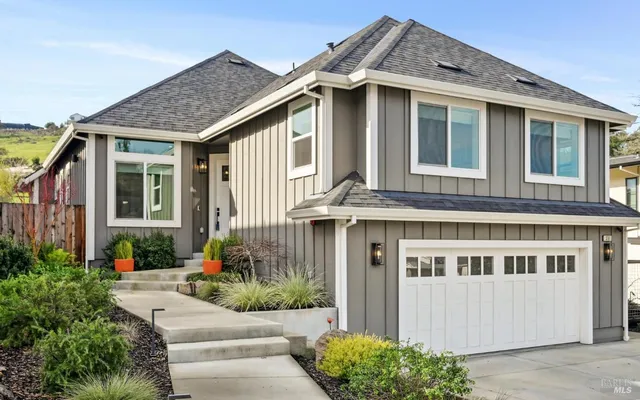 a front view of a house with a garden