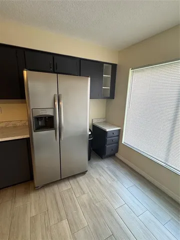 a kitchen with a refrigerator and a sink
