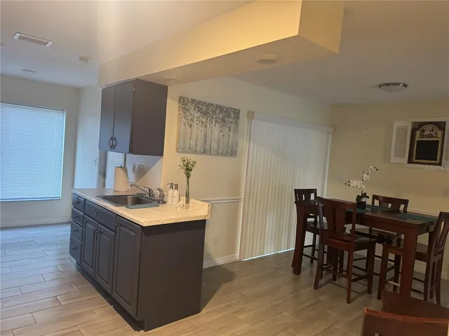 a kitchen with a table and chairs in it