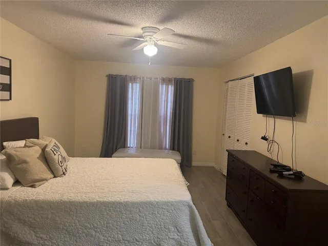 a bedroom with a bed and a flat screen tv