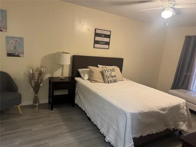a bedroom with bed and a couch