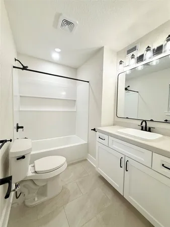 a bathroom with a sink a toilet a mirror and a bathtub