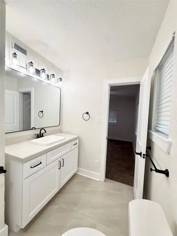 a spacious bathroom with a double vanity sink and mirror