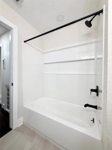 a bathroom with a shower and a bath tub