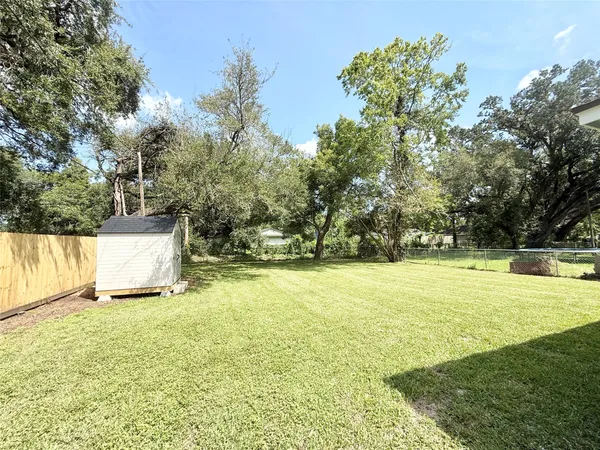 a white house that has a tree in front of it