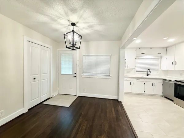 a view of a kitchen with wooden floor