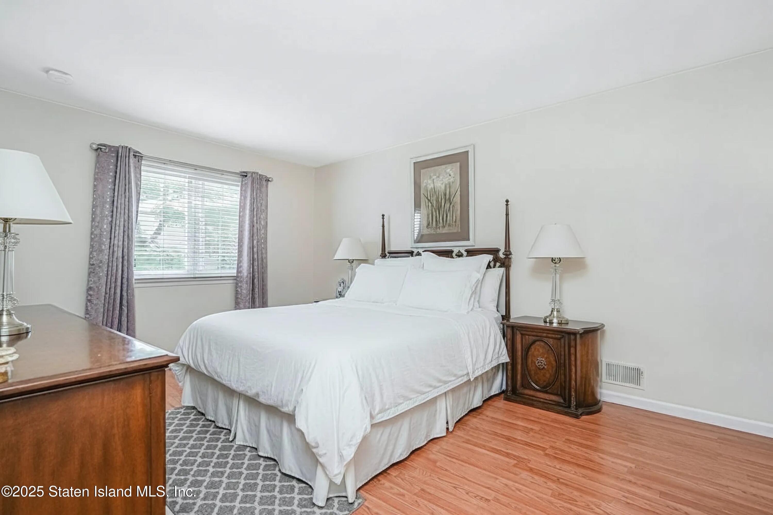 45 Sommer Avenue Staten Island, NY 10314 - Photo 16 of 31 a bedroom with a bed and wooden floor