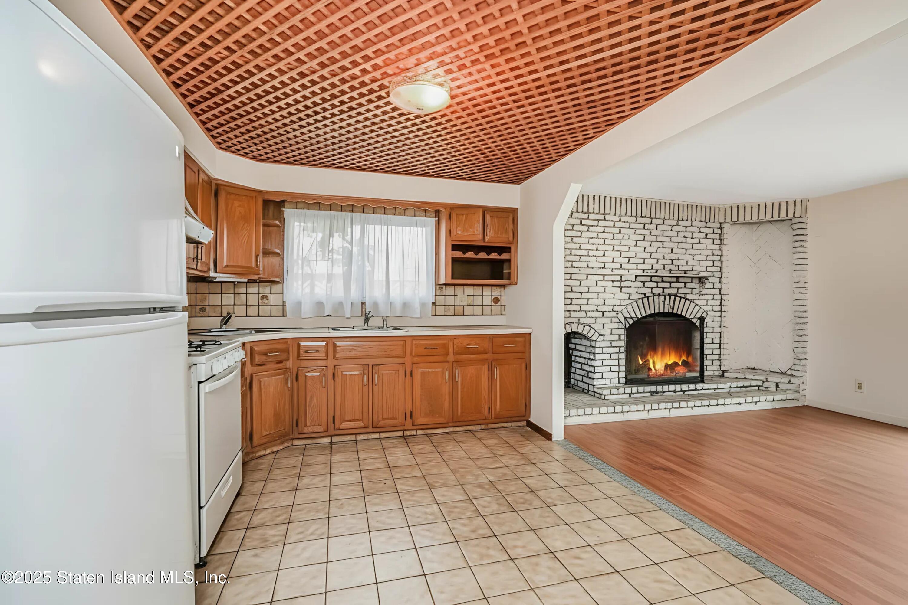 45 Sommer Avenue Staten Island, NY 10314 - Photo 20 of 31 a view of open kitchen with a sink a fireplace and a refrigerator