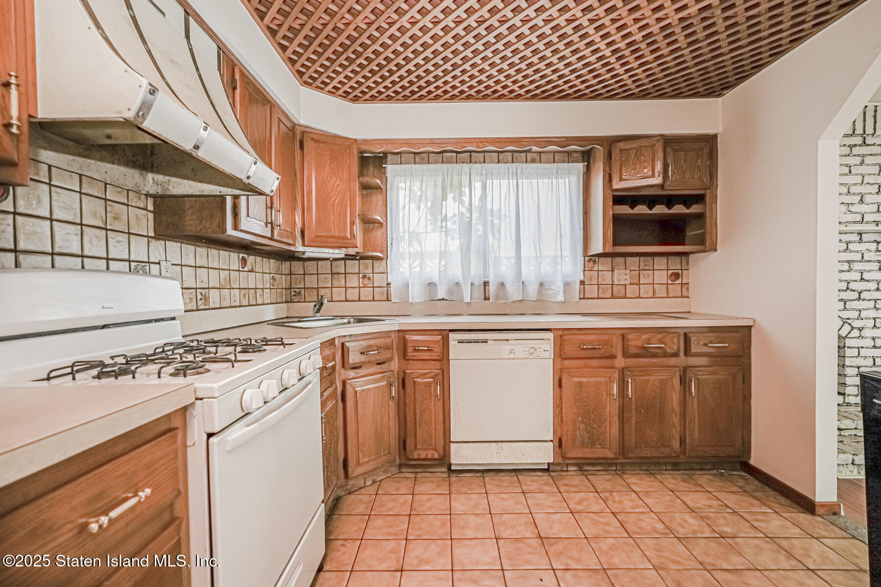 45 Sommer Avenue Staten Island, NY 10314 - Photo 21 of 31 a kitchen with a sink stove and cabinets