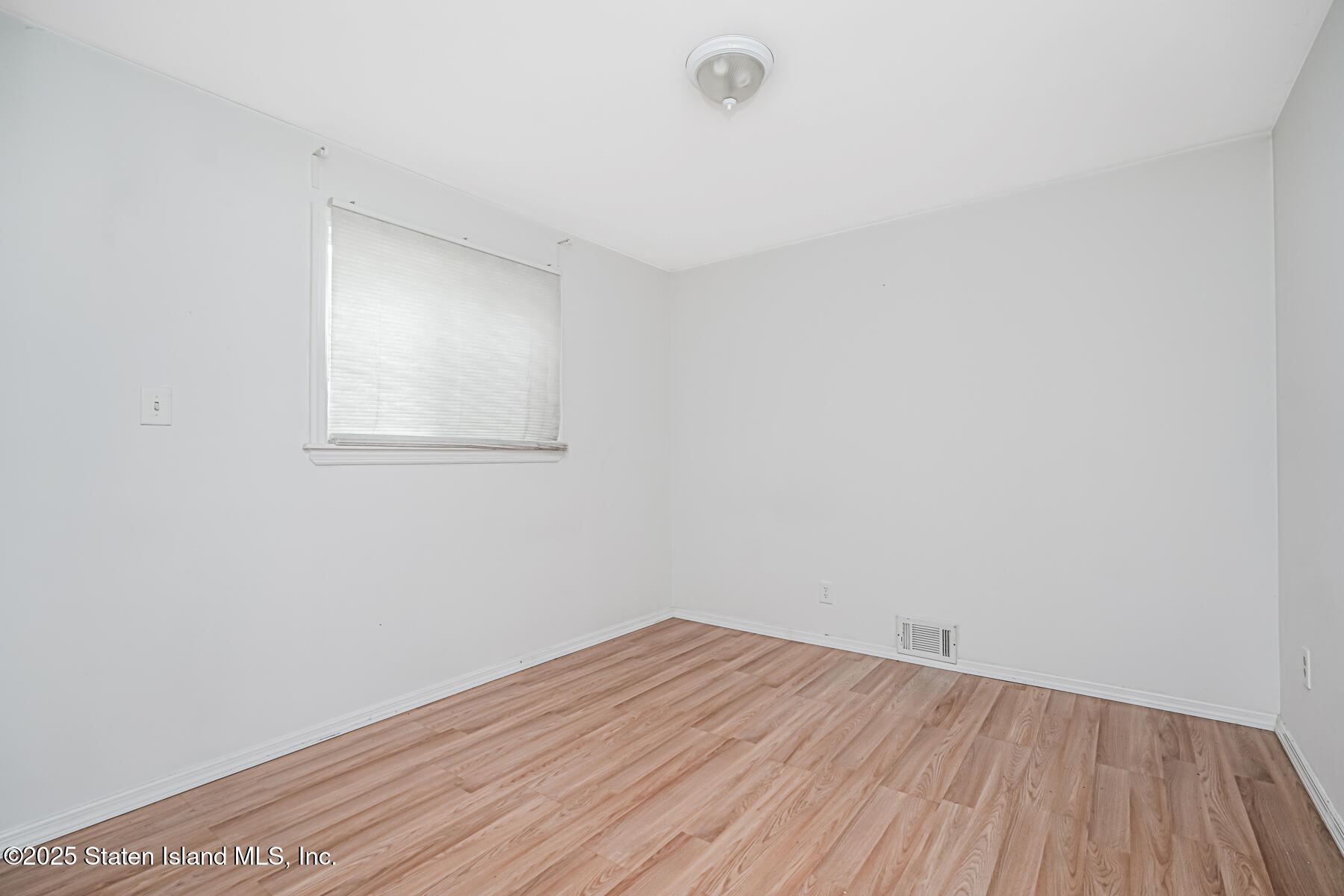 45 Sommer Avenue Staten Island, NY 10314 - Photo 22 of 31 an empty room with wooden floor and windows