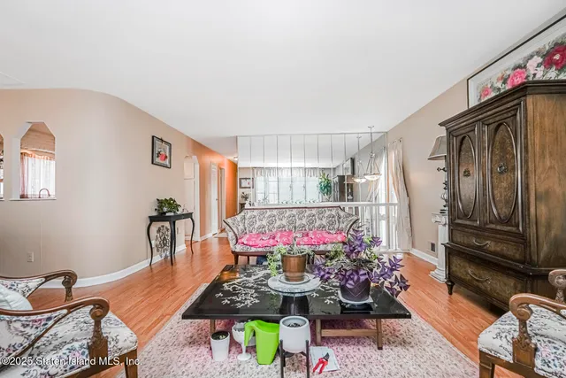 a living room with furniture and flowers