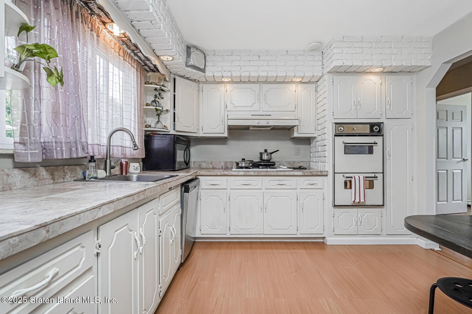 45 Sommer Avenue Staten Island, NY 10314 - Photo 7 of 31 a kitchen with stainless steel appliances a sink a stove a refrigerator cabinets and a counter top space