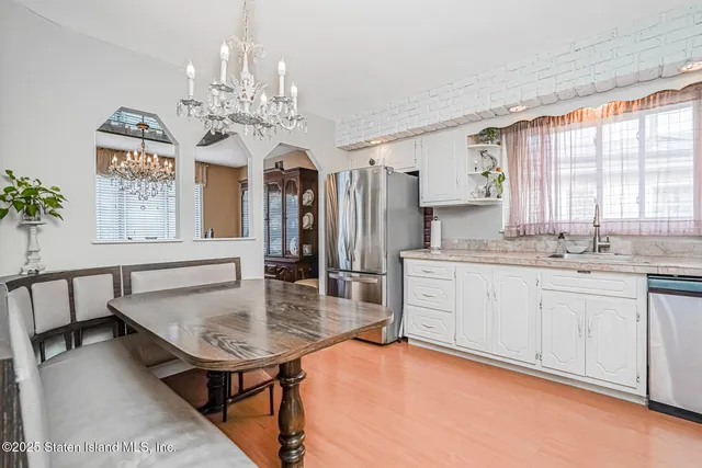 a kitchen with stainless steel appliances granite countertop a sink dishwasher and cabinets with wooden floor