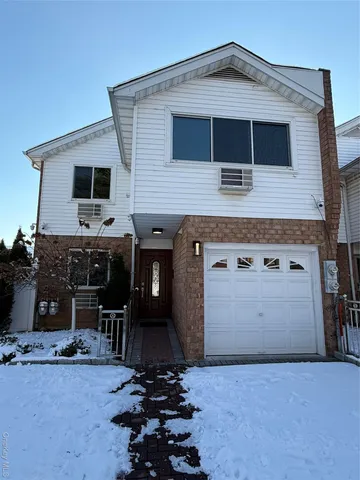 a front view of a house with garage