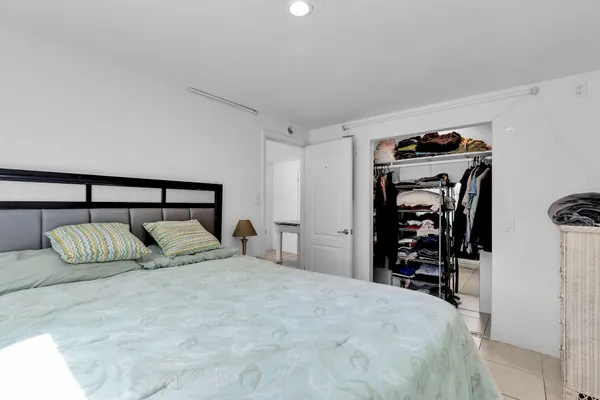 a bedroom with a bed and walk in closet