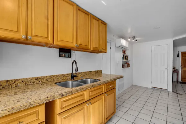 a kitchen with stainless steel appliances granite countertop a sink and cabinets