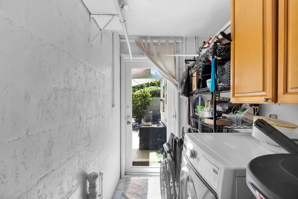 a kitchen with a sink a counter top space and cabinets