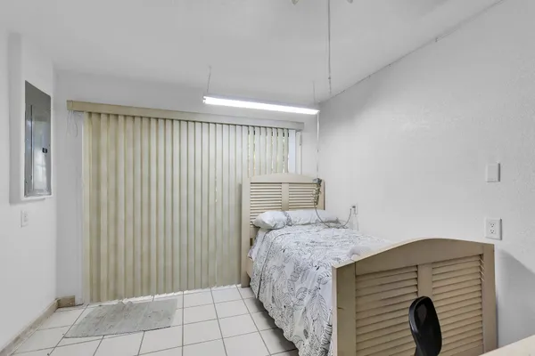 a bedroom with a bed and a chair