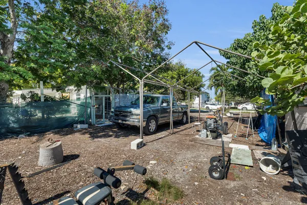 a view of backyard with wheel chair and potted plants