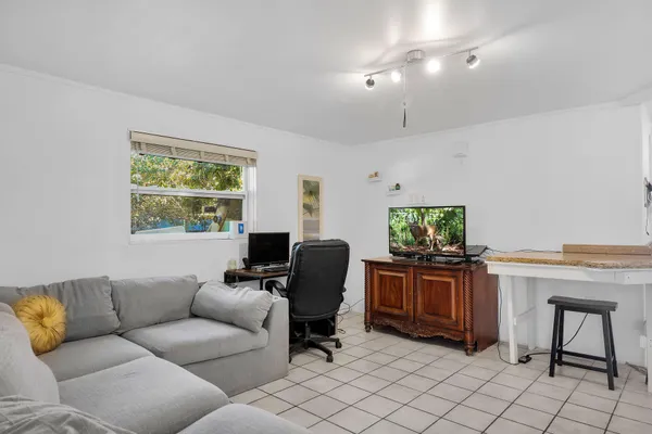 a living room with furniture a window and a flat screen tv